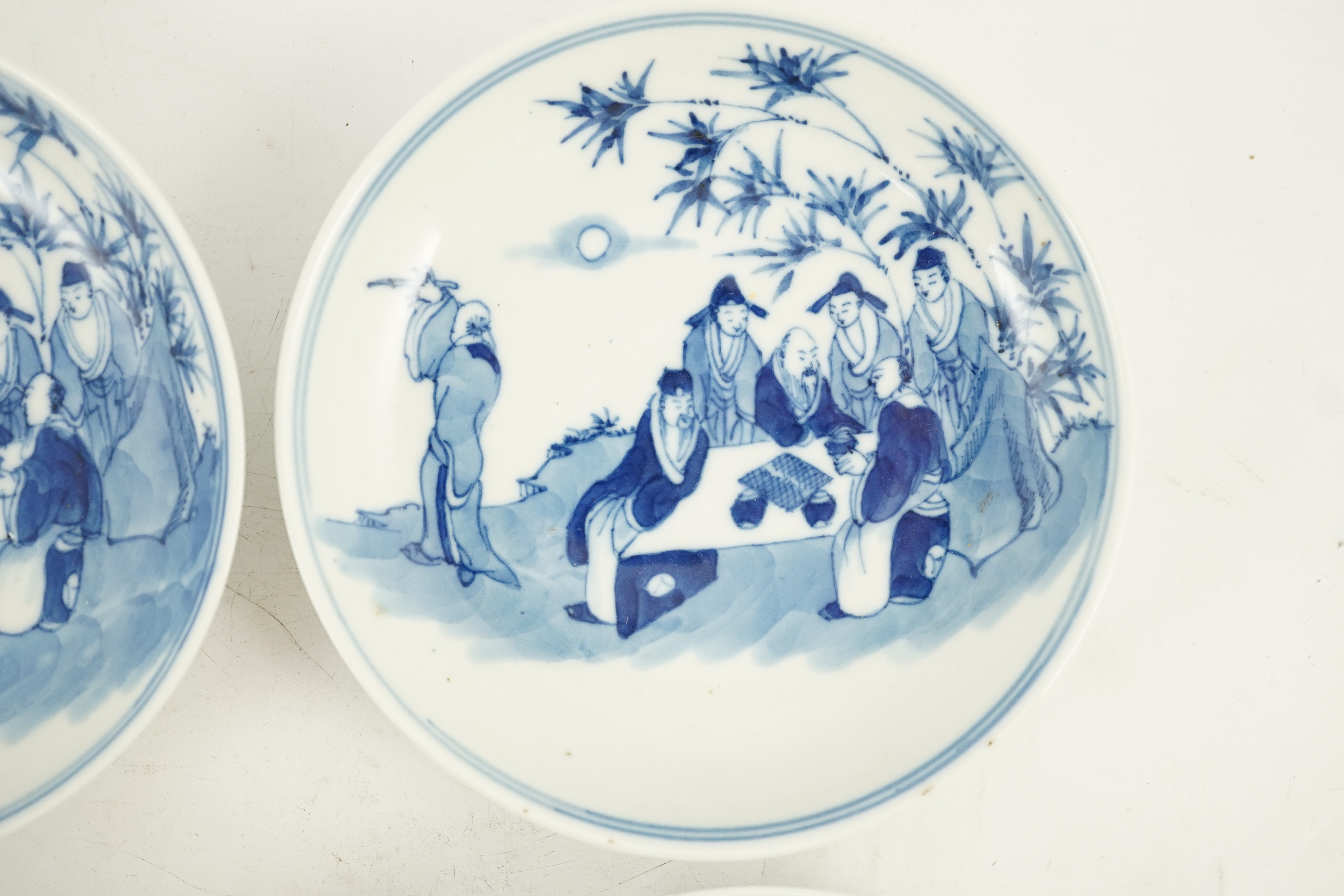 A set of six Chinese ‘Seven Sages of the Bamboo Grove’ saucer dishes, Kangxi marks but late 19th century, 12.3cm diameter